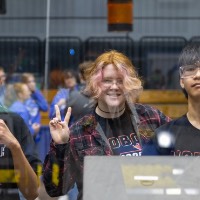 Three teammates smile during the 2026 GVSU West MI District Event